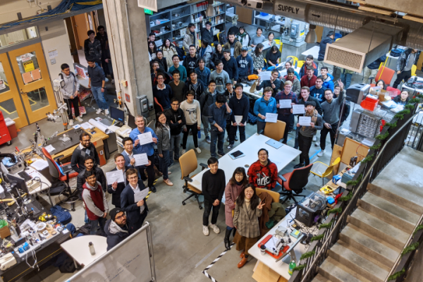 Students pose with their final projects for Machine Learning: Deep Learning in Hackerman Hall.