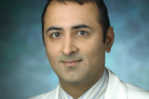 Headshot of Haris Sair wearing a Johns Hopkins Medicine doctor's coat.