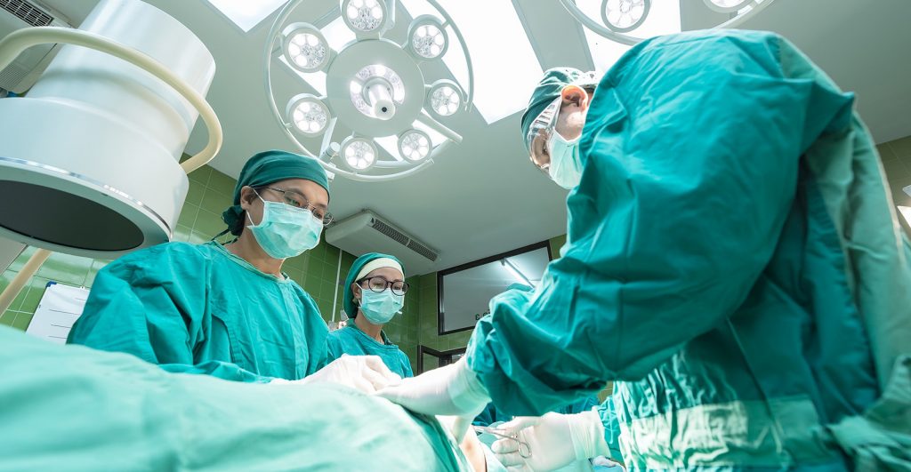 Surgeons in the operating room, operating on a patient.