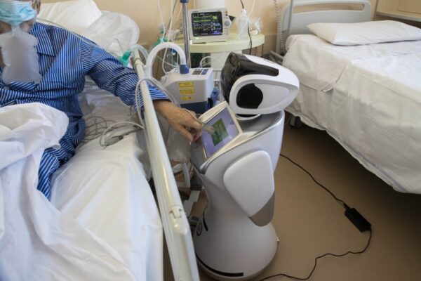 A robot tends to a COVID-19 patient in the intensive care unit of an Italian hospital.