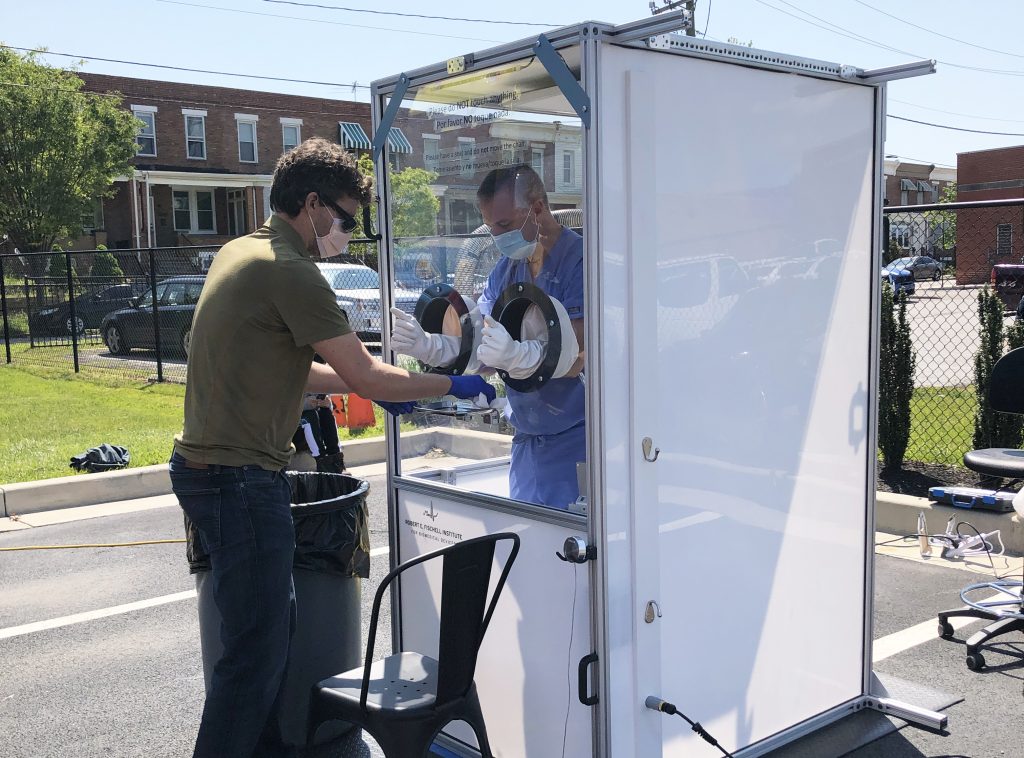 A mobile testing booth in a parking lot.