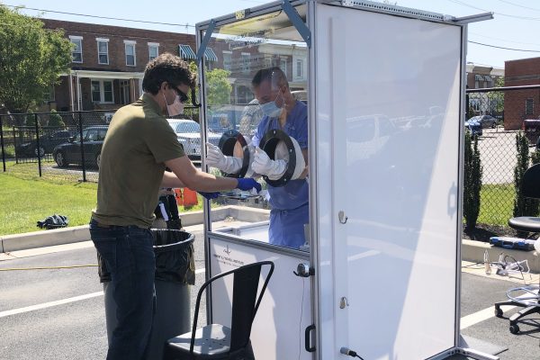 A mobile testing booth in a parking lot.