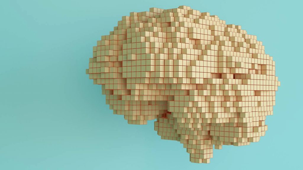Wooden blocks form the shape of the human brain in front of a teal background.