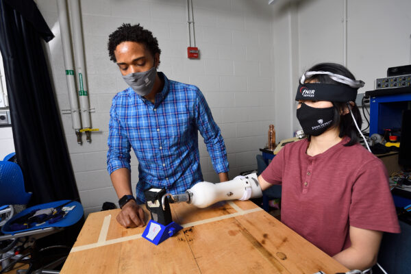 Mechanical Engineering Professor Jeremy Brown and graduate student Alexandra Miller demonstrate a sleeve used to give haptic feedback from prosthetics.