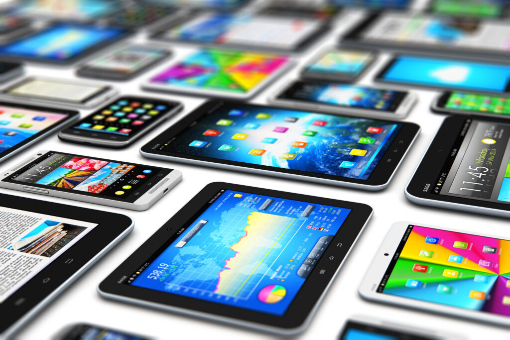 3D render illustration of a group of tablets and touchscreen smartphones with various internet applications with colorful interfaces, icons, and buttons isolated on a white background.