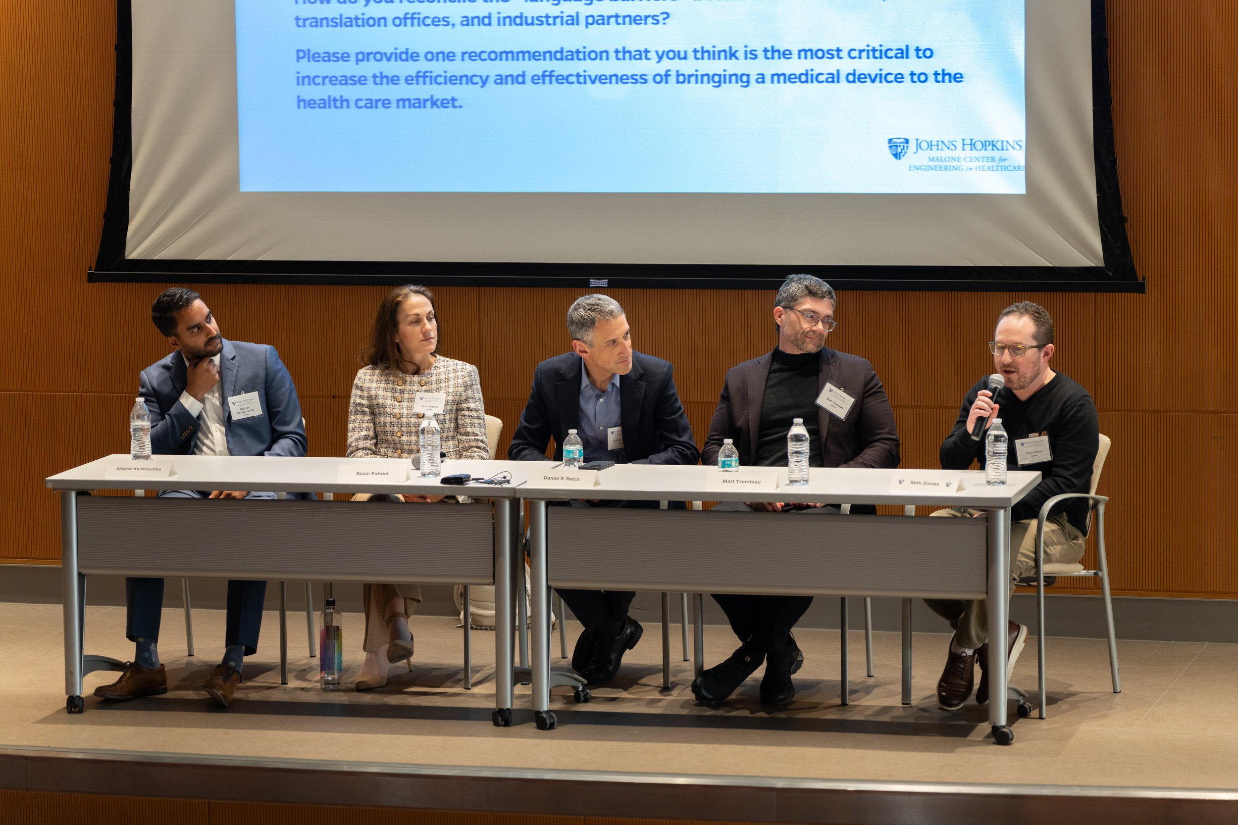 A panel of speakers sit and discuss at the 2024 Malone symposium.