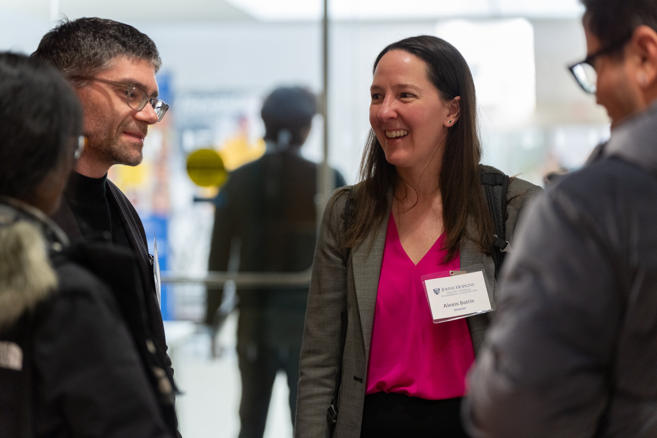 Alexis Battle and others stand and chat after the 2024 Malone symposium.