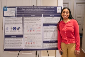 Shreya Raman stands next to her poster.