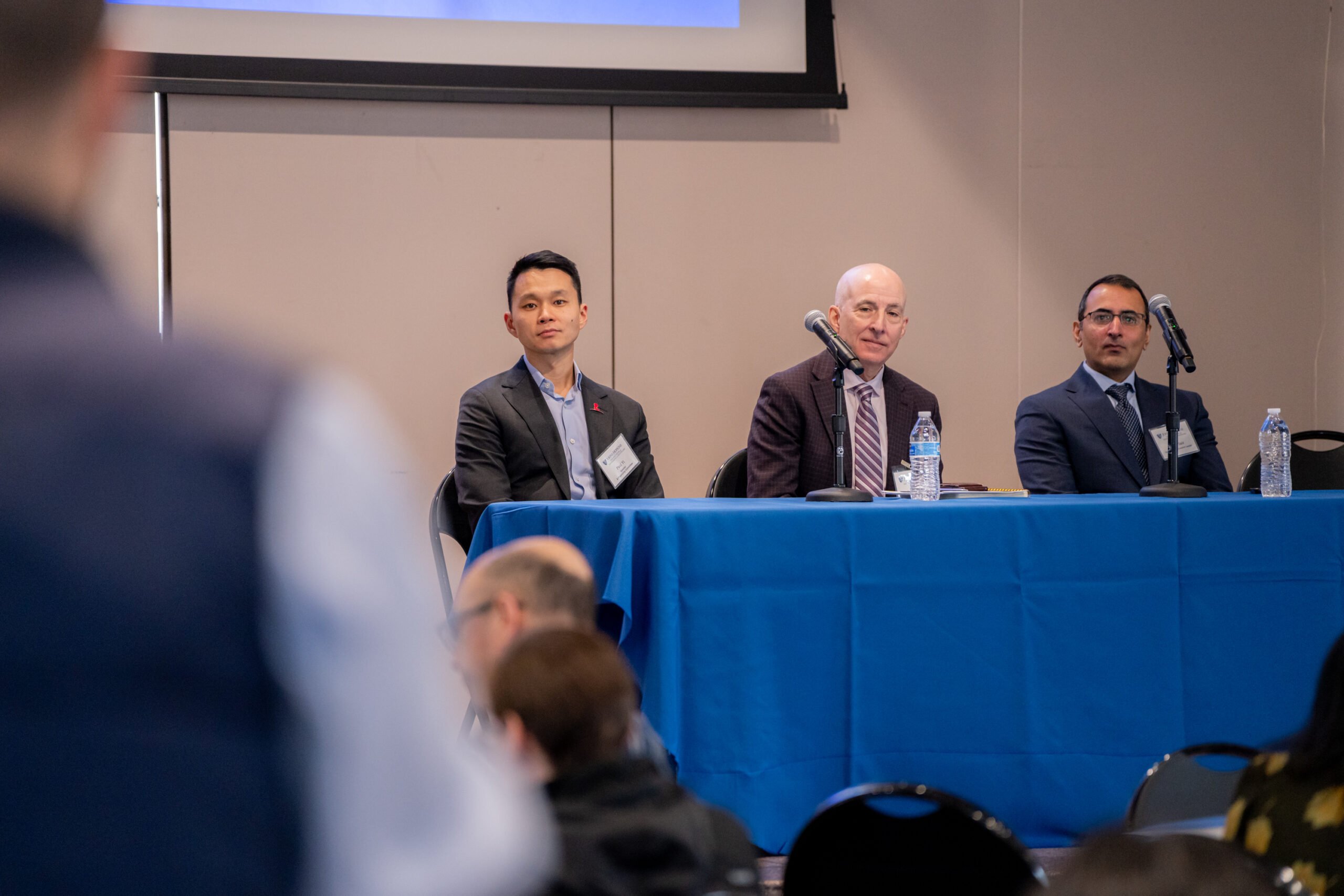 Malone_Symposium_25-49 An audience member asks a panel (comprising Paul Yi, Andrew Menard, and Haris Sair) a question.