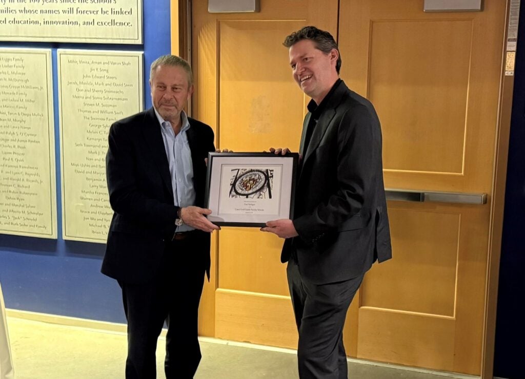 Ed Schlesinger presents Axel Krieger with his framed appointment letter.