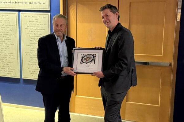 Ed Schlesinger presents Axel Krieger with his framed appointment letter.